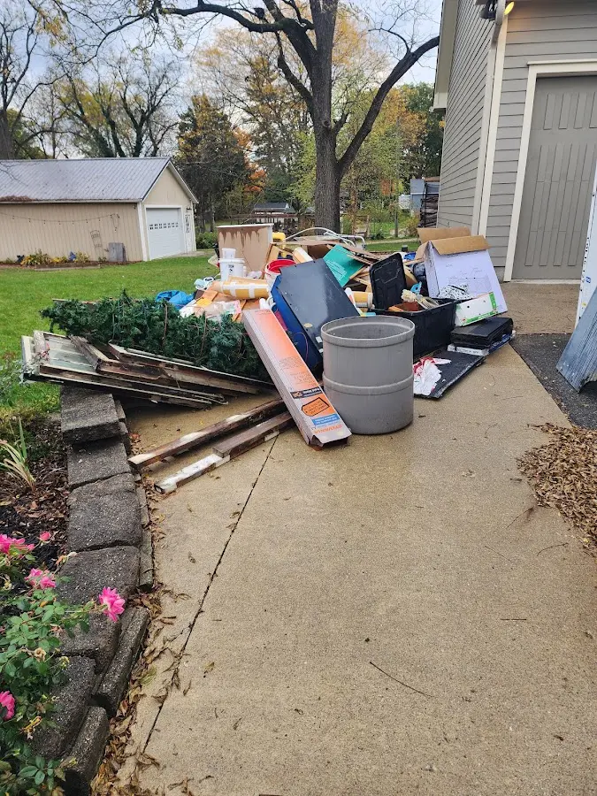 Dumpster being loaded with debris for Estate Cleanout Dumpster Rental in Wilder
